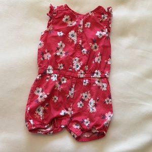 Coral romper with white and light pink flowers